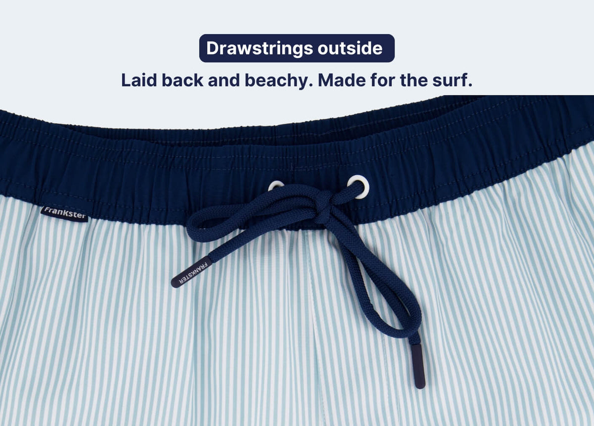 Men's Shorts close-up with light blue and white vertical stripes, a navy waistband, and an external drawstring tie