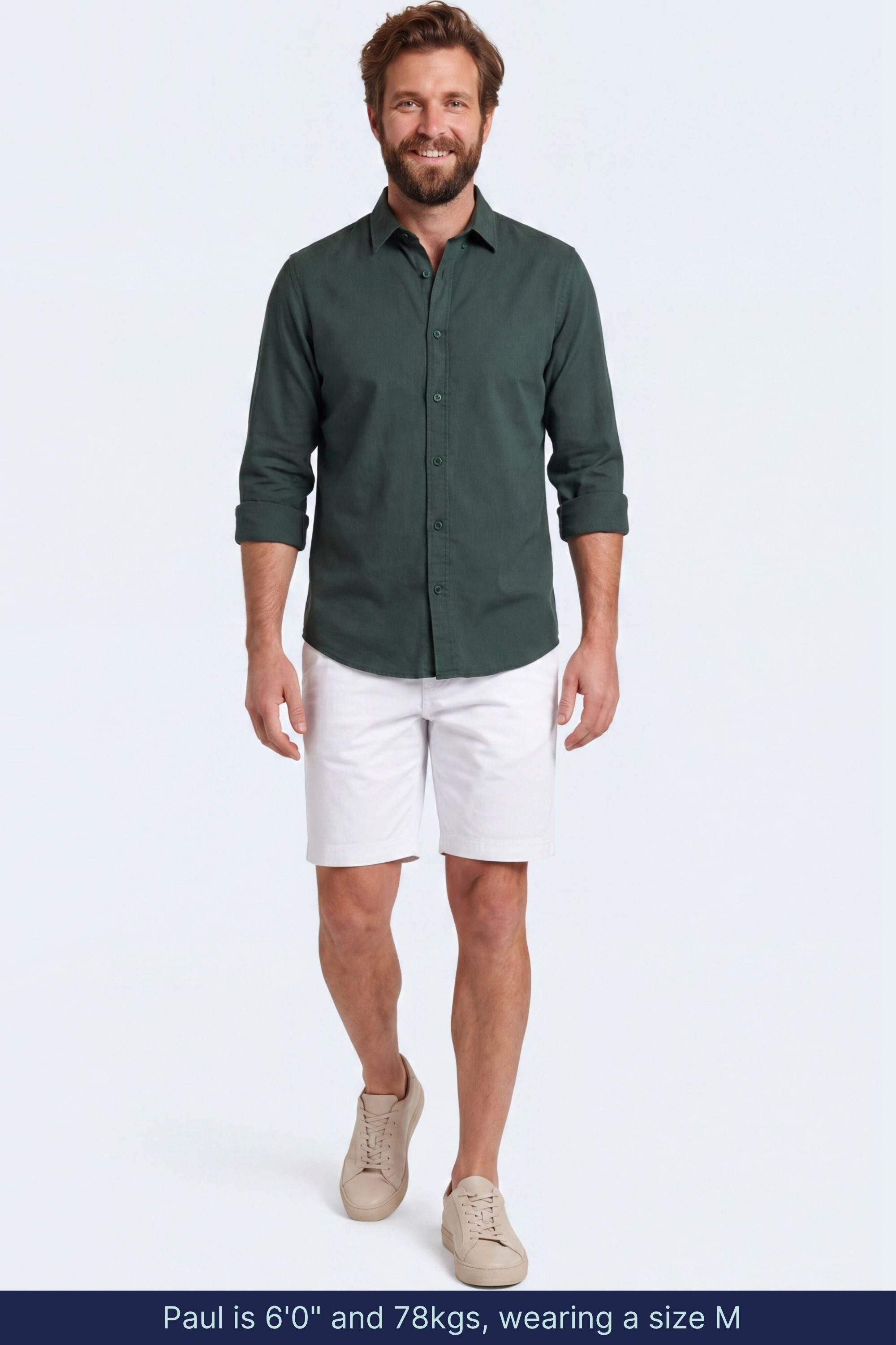 Man wearing white cotton blend Whitecaps * The Everydays men's shorts by Frankster paired with a dark green shirt and beige sneakers, showcasing comfortable and stylish men shorts.