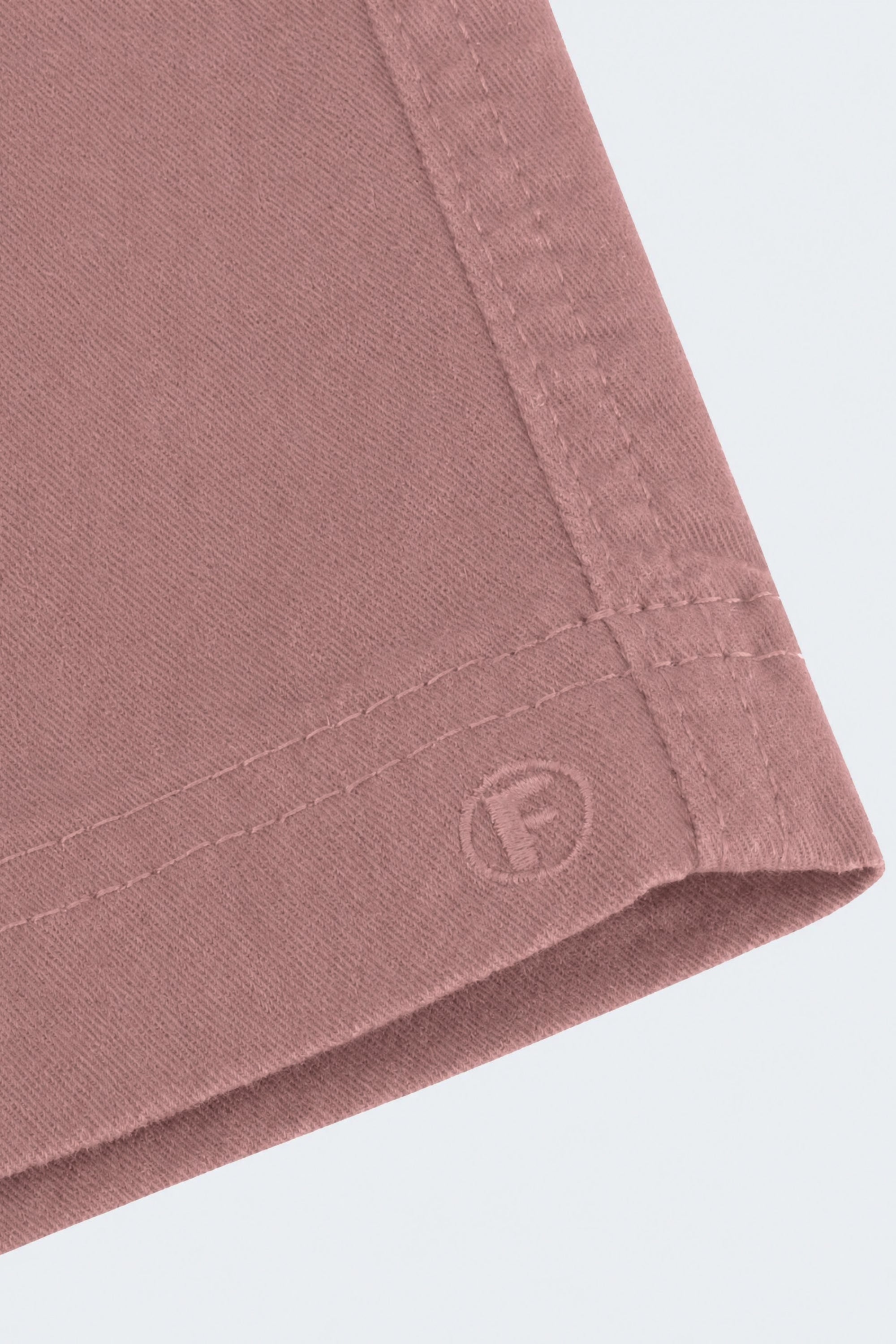 Close-up of dusty pink men's shorts corner showing soft, durable fabric and stitched hem from Frankster's Sundowners * The Everydays collection.