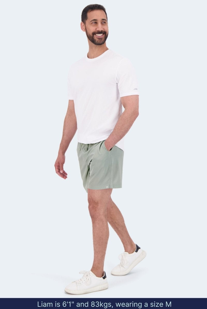 Frankster Evergreens * The Sporties Men's Shorts in sage green, styled on a model for casual all day wear