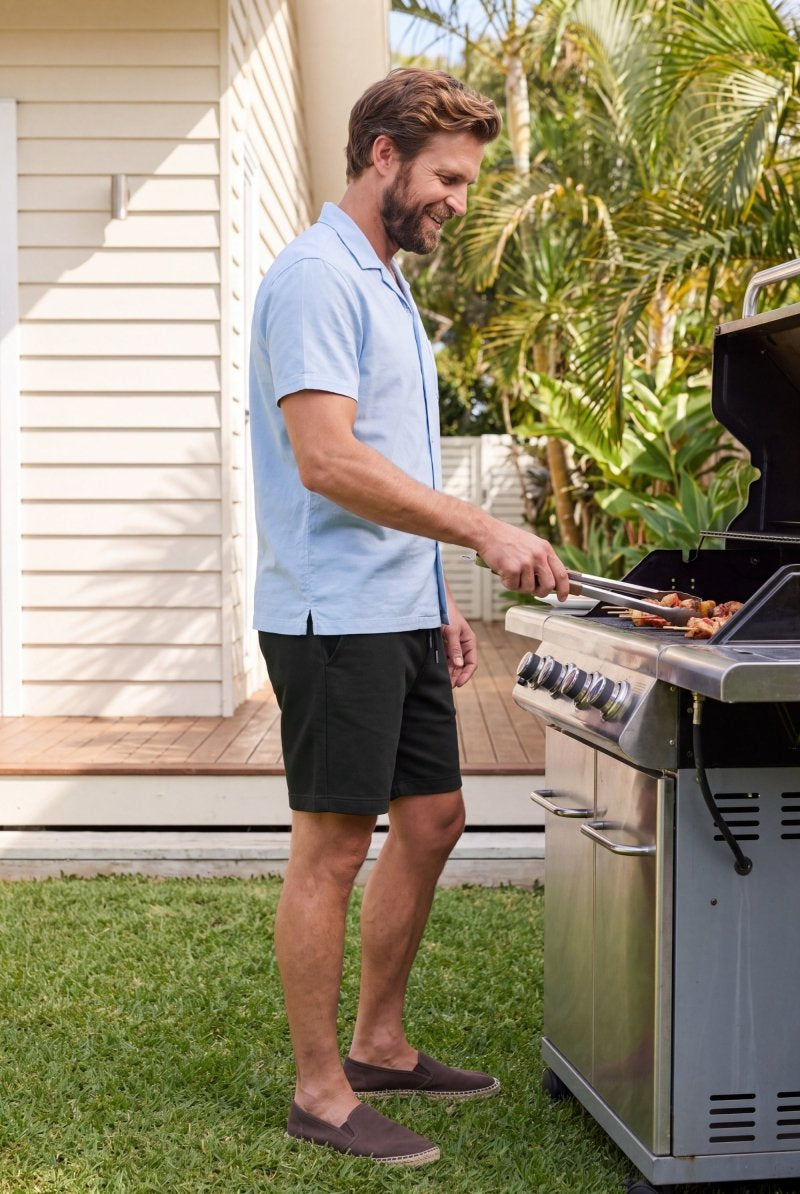 Midnights * The Comfies by Frankster black Men's Shorts in soft fabric worn while grilling outdoors for all day comfort