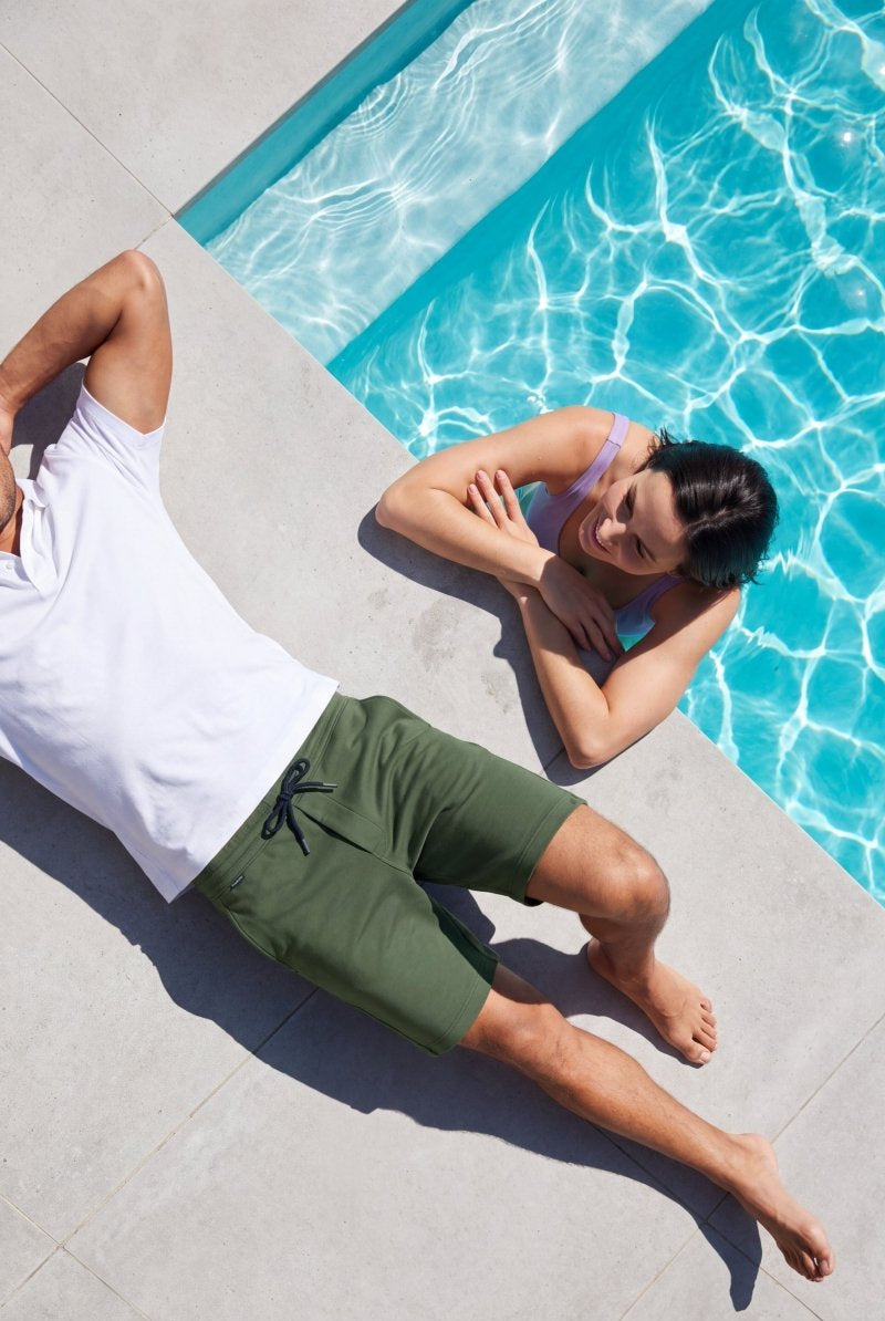 Rebels * The Comfies by Frankster green Men's Shorts in soft fabric worn beside a swimming pool