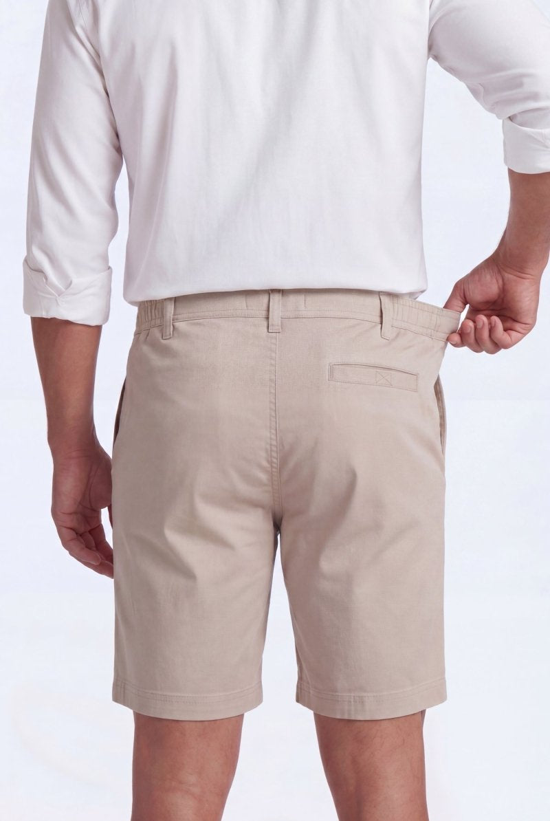 Back view of a man wearing beige Shores * The Everydays men's shorts by Frankster, made from soft, comfortable material with a partly elasticated waistband.