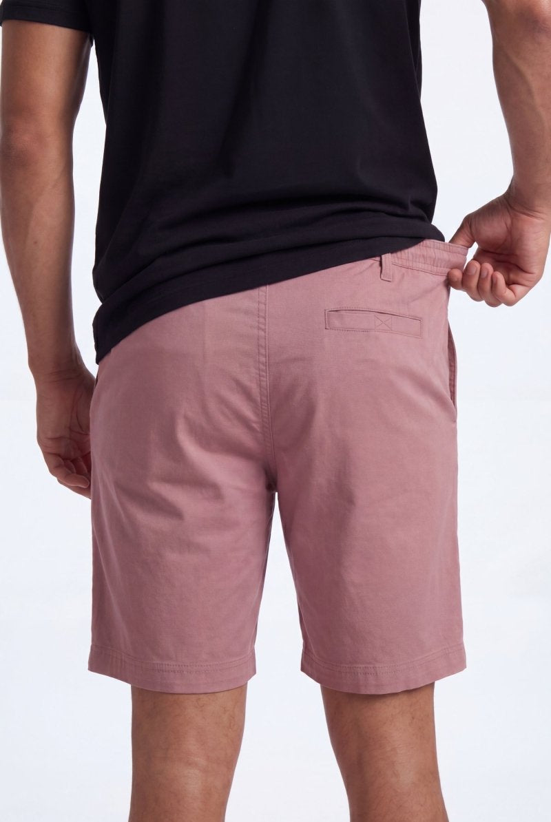 Back view of a man wearing dusty pink Sundowners * The Everydays men's shorts by Frankster, made from soft, breathable material with a comfortable fit.
