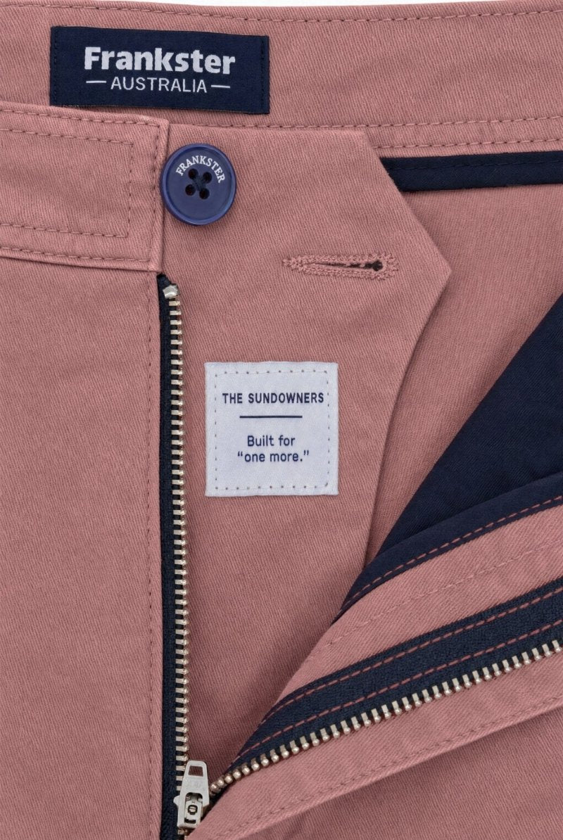 Close-up of Frankster Sundowners * The Everydays men's shorts in dusty rose colour, featuring cotton fabric, navy button and zipper detail, and inner navy lining.