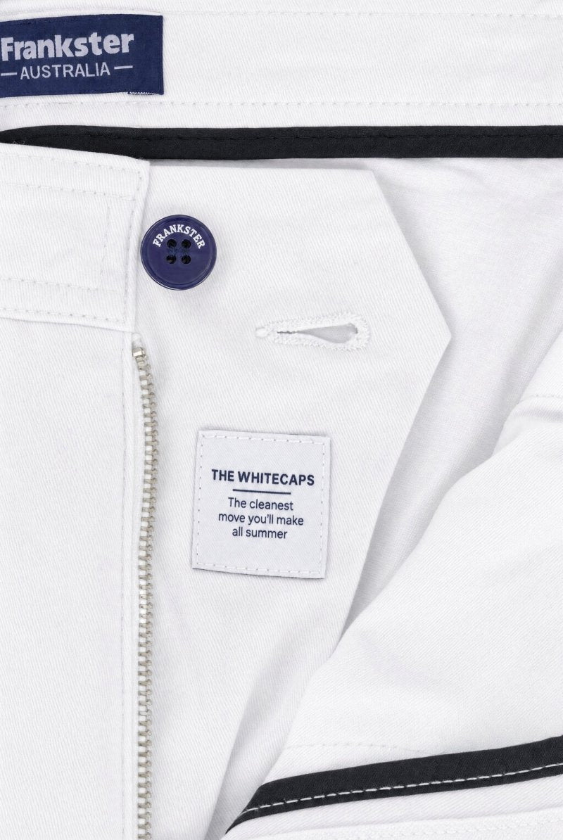 Close-up of white cotton men's shorts from Frankster, featuring a navy branded button and a clean, minimal design from the Whitecaps * The Everydays collection.