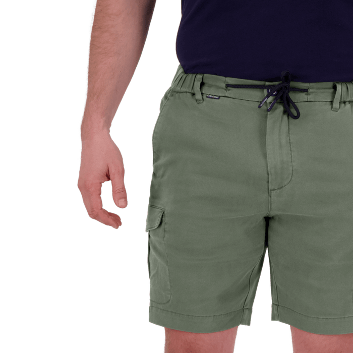 Close-up of a man wearing olive green cargo shorts with a black drawstring waistband and a navy shirt