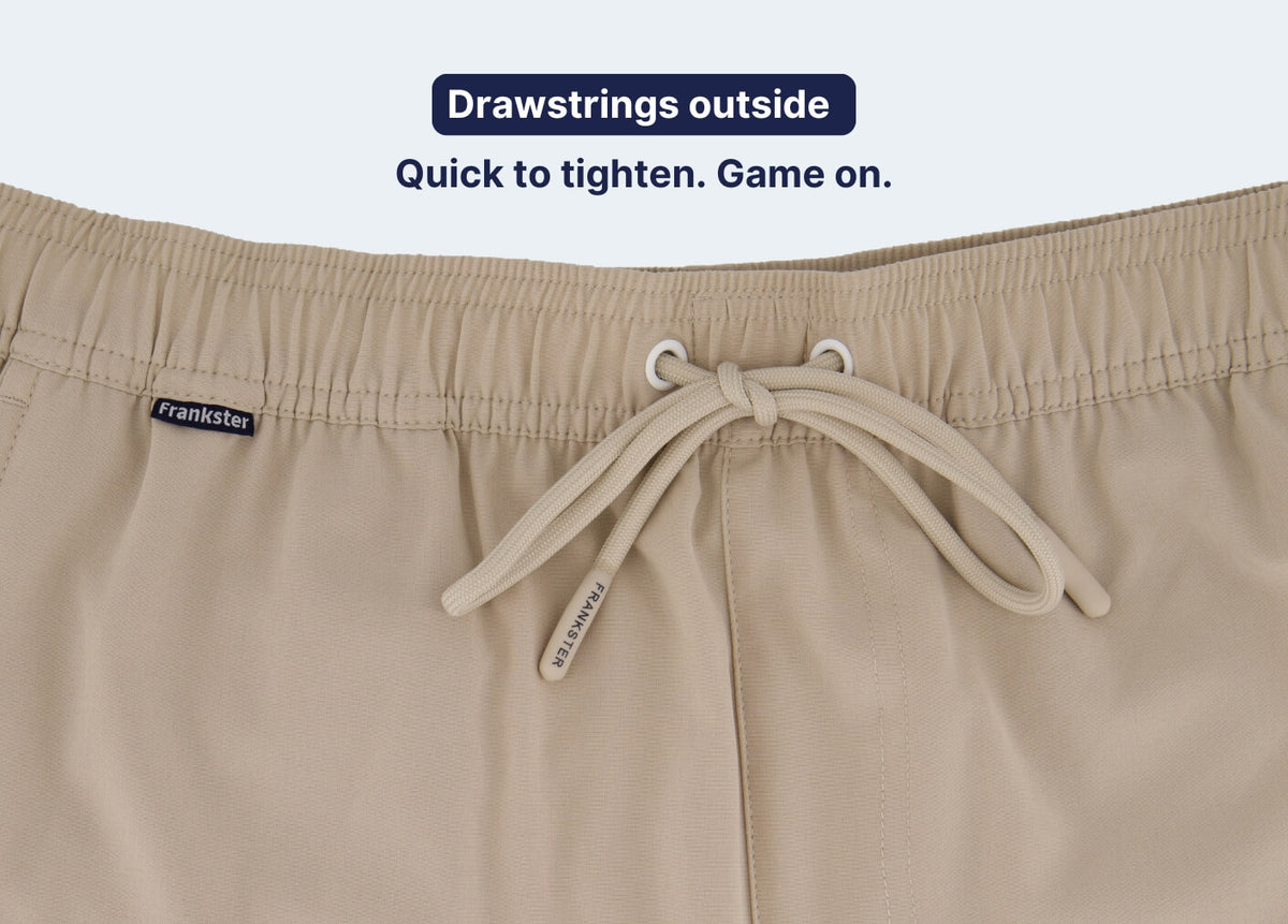 Close up of beige Men's Shorts with an elastic waistband and external drawstrings in soft lightweight fabric