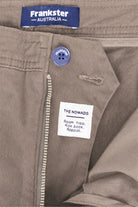 Close-up of taupe men's shorts by Frankster showing premium cotton fabric with a zipper and button closure, part of the Nomads * The Everydays collection.