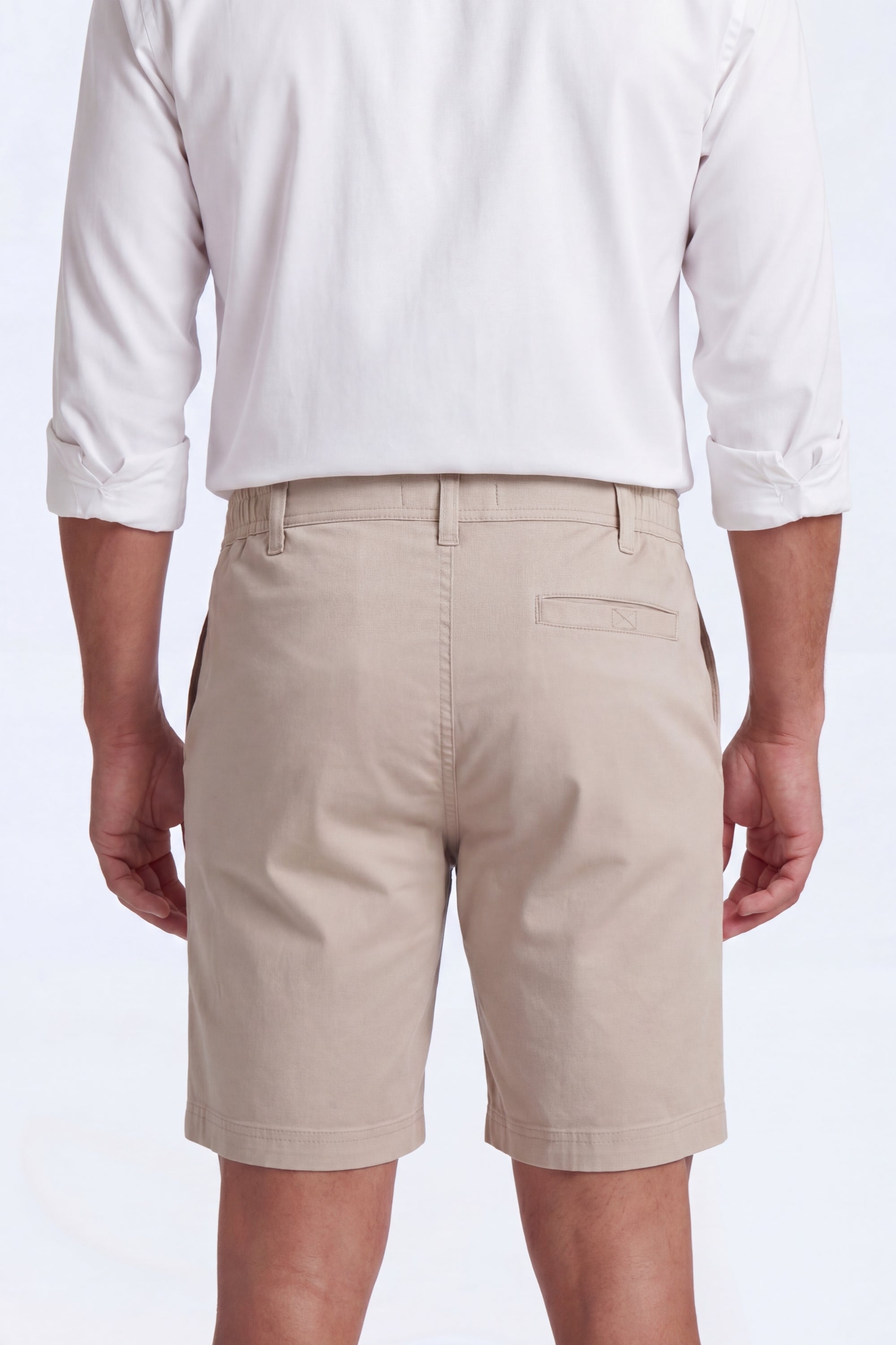 Back view of a man wearing beige Shores * The Everydays men's shorts by Frankster, made from soft, comfortable fabric ideal for all-day wear
