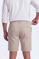 Back view of a man wearing beige Shores * The Everydays men's shorts by Frankster, made from soft, comfortable material with a partly elasticated waistband.