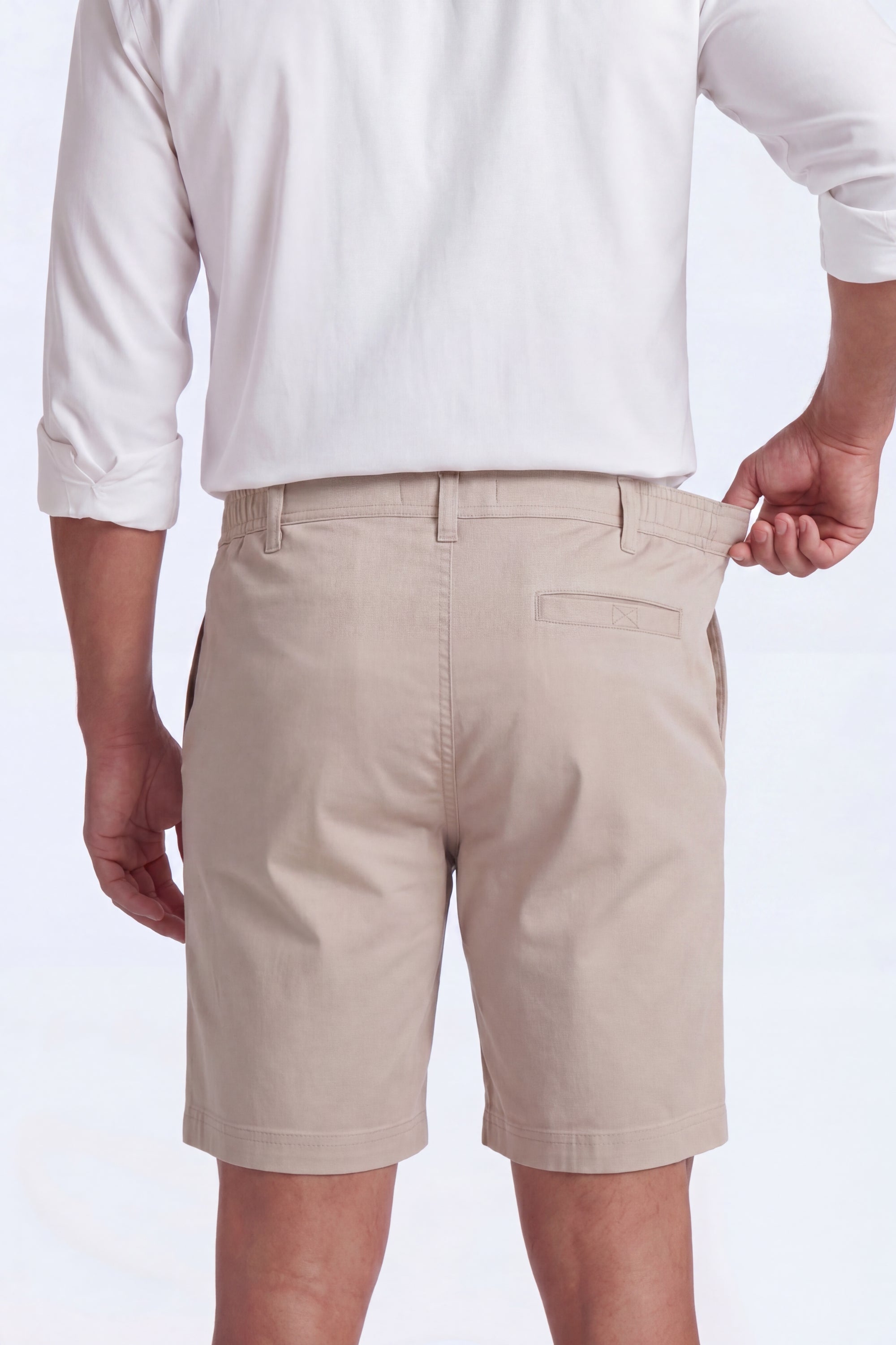 Back view of a man wearing beige Shores * The Everydays men's shorts by Frankster, made from soft, comfortable material with a partly elasticated waistband.