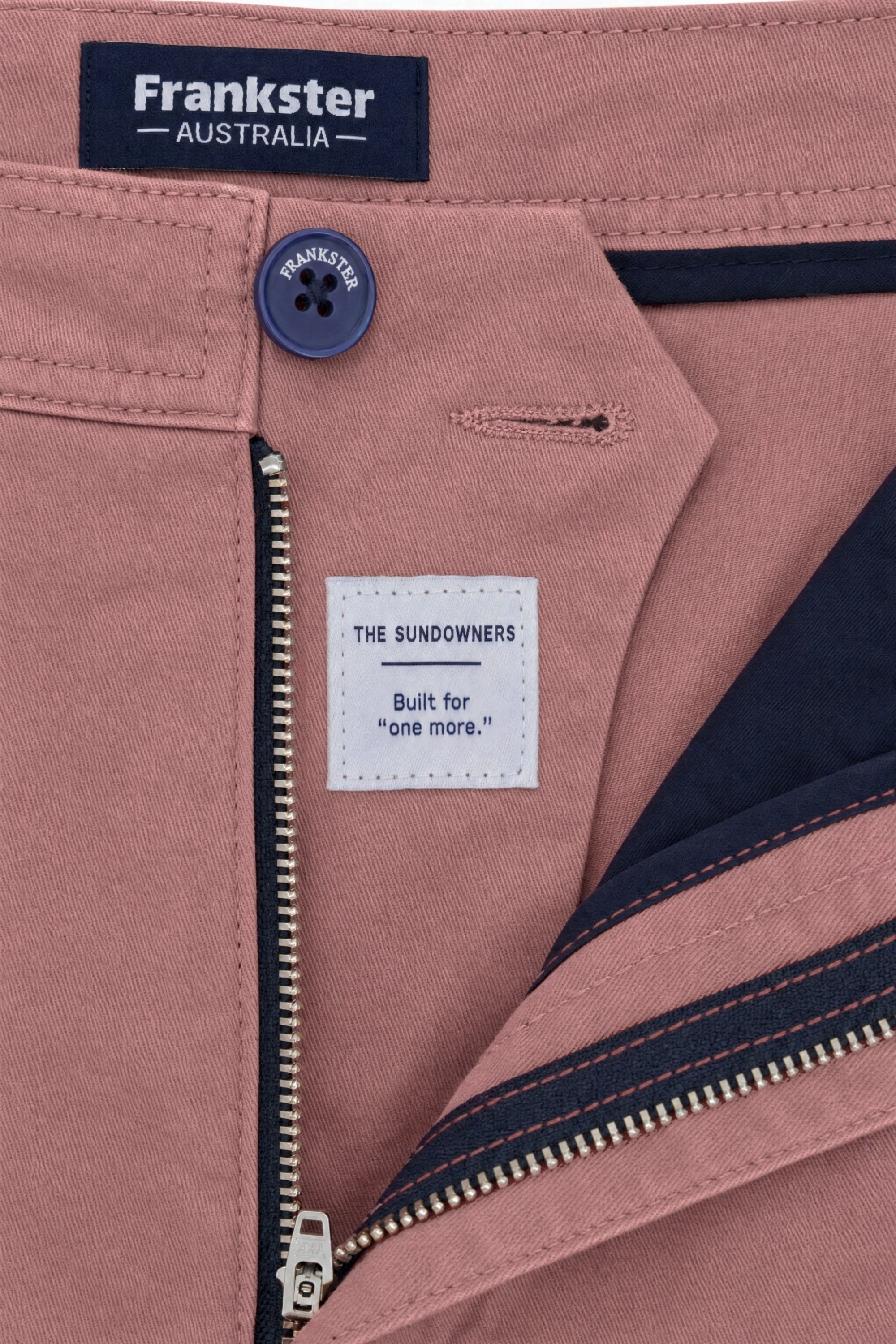 Close-up of Frankster Sundowners * The Everydays men's shorts in dusty rose colour, featuring cotton fabric, navy button and zipper detail, and inner navy lining.