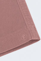 Close-up of dusty pink men's shorts corner showing soft, durable fabric and stitched hem from Frankster's Sundowners * The Everydays collection.