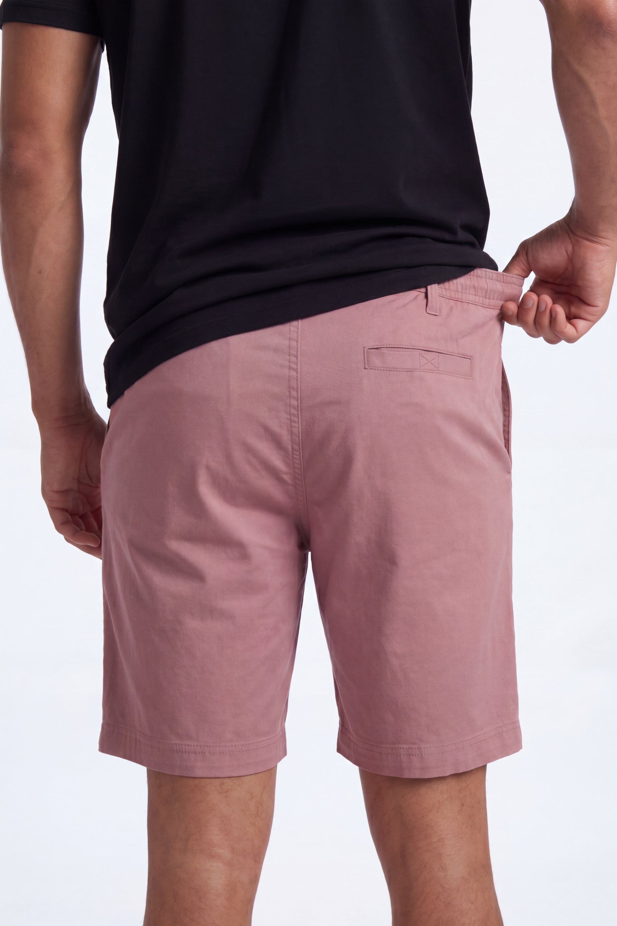 Back view of a man wearing dusty pink Sundowners * The Everydays men's shorts by Frankster, made from soft, breathable material with a comfortable fit.