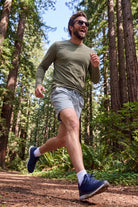 Frankster Blueprints * The Sporties Men's Shorts in light grey worn by a runner on a forest trail