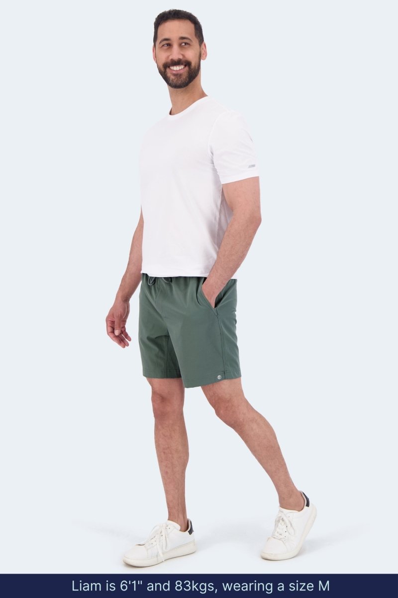 Frankster Caddies * The Sporties Men's Shorts in sage green fabric worn by a male model with a white T shirt