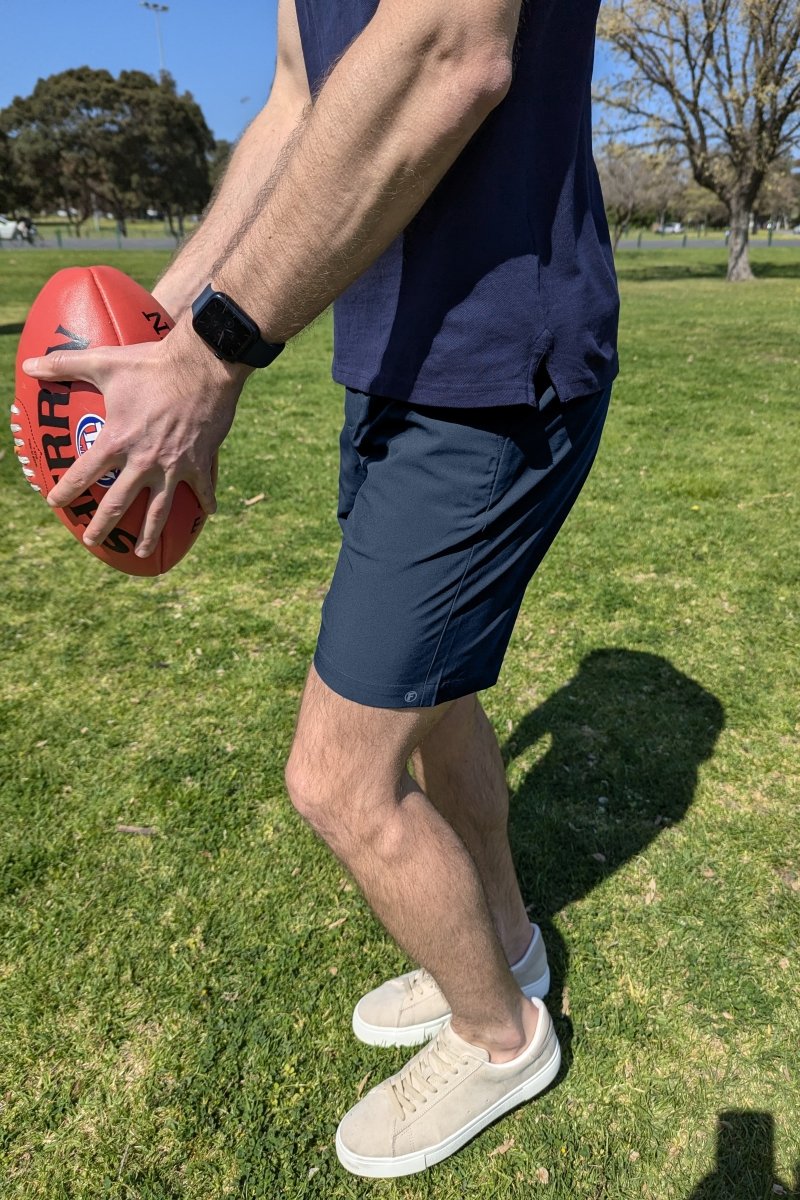 Man wearing Frankster Chillers * The Actives dark blue lightweight men's shorts playing outdoors on a sunny day