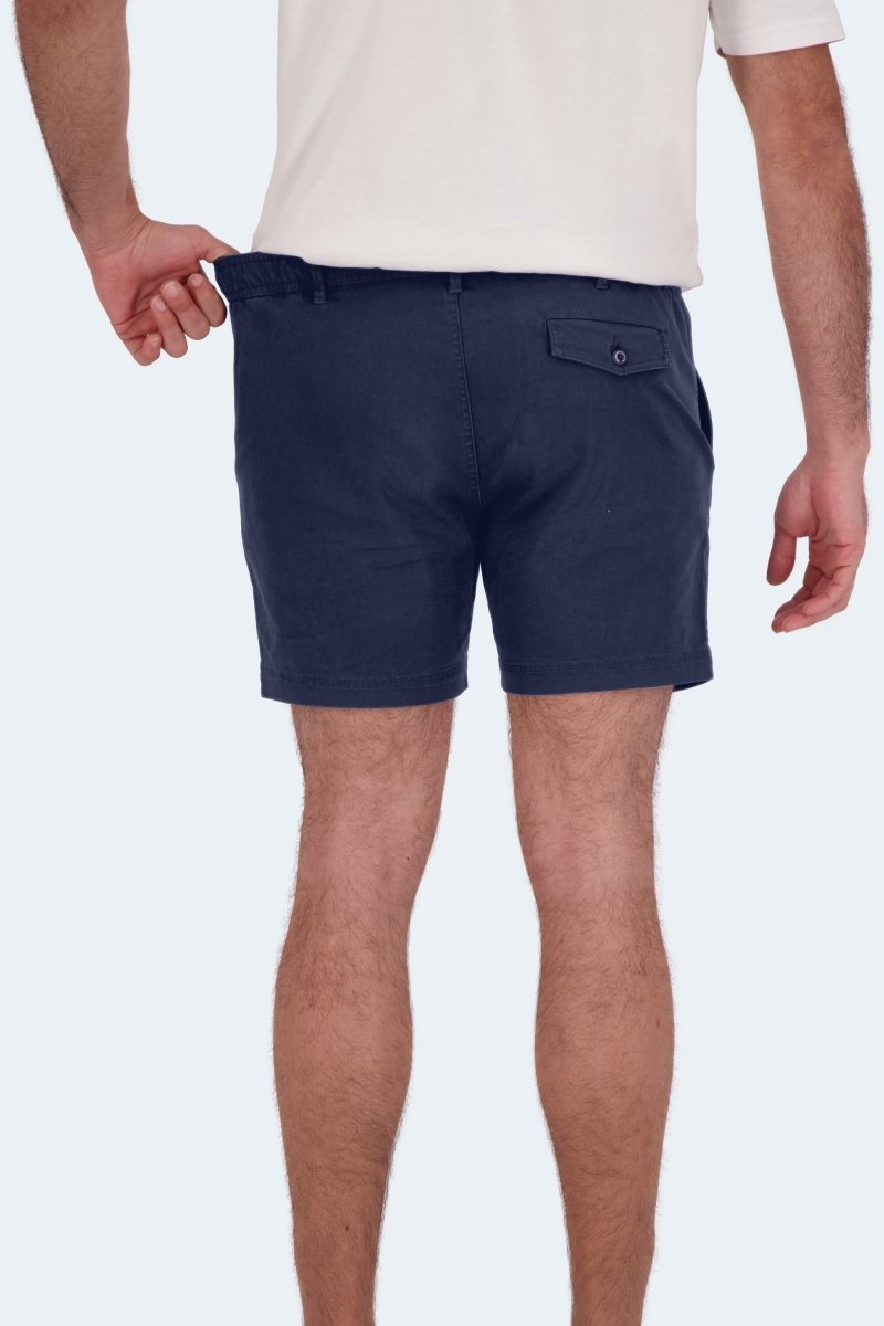 Man wearing Frankster Chillers * The Shorties dark blue stretch cotton men's shorts standing with back facing camera