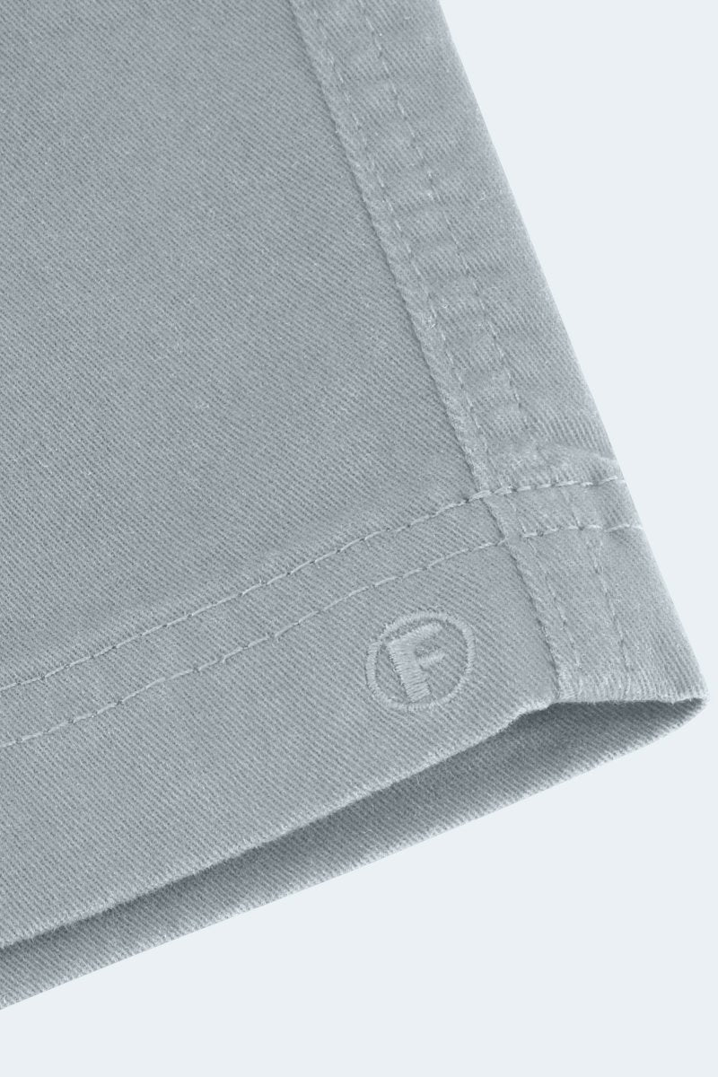 Close-up of Frankster Coastlines * The Everydays men's shorts in blue grey stretch cotton showing detailed stitching and fabric texture