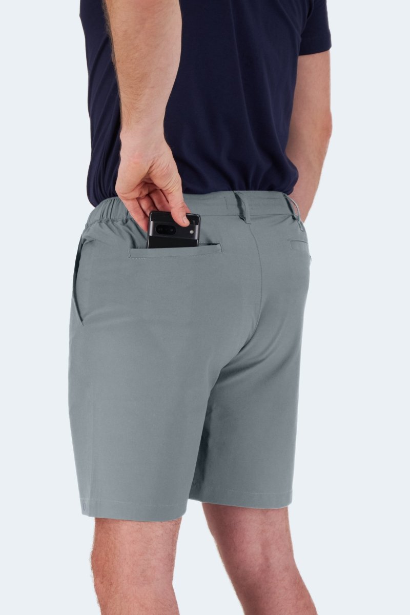 Man wearing Frankster Coastlines * The Actives blue grey lightweight men's shorts with back pocket holding a phone