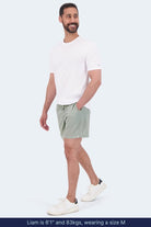 Frankster Evergreens * The Sporties Men's Shorts in sage green, styled on a model for casual all day wear