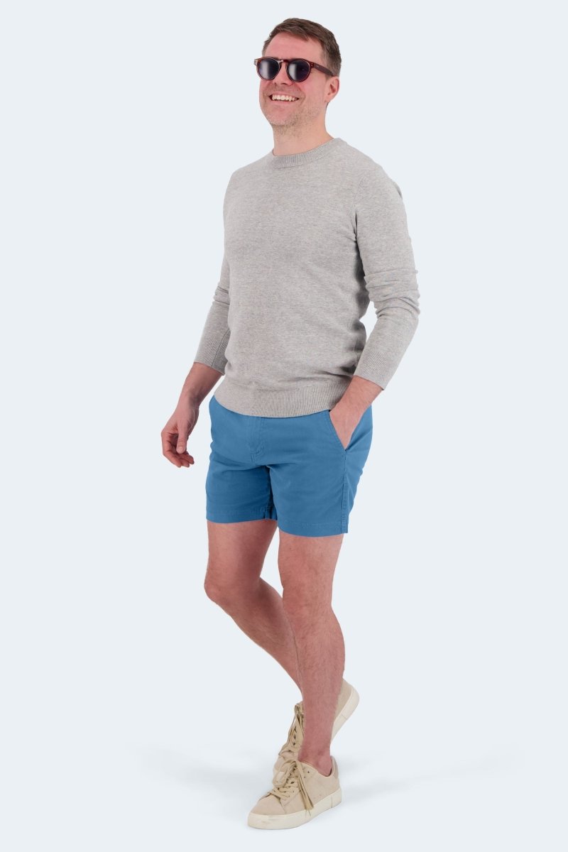 Man wearing Frankster Harbors * The Shorties mid blue stretch cotton men's shorts with a light gray sweater and sneakers
