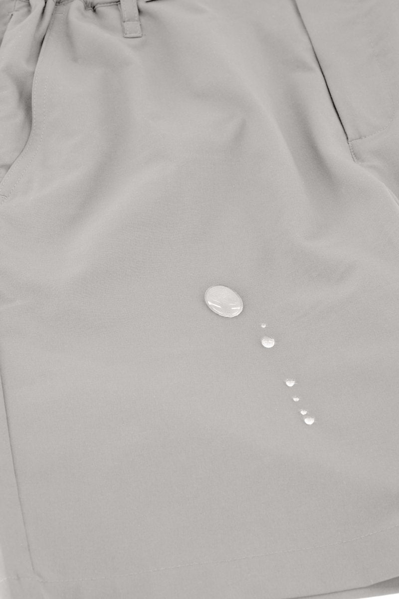 Close-up of light grey Frankster Lunars * The Actives men's shorts made from water-resistant lightweight fabric with water droplets on surface