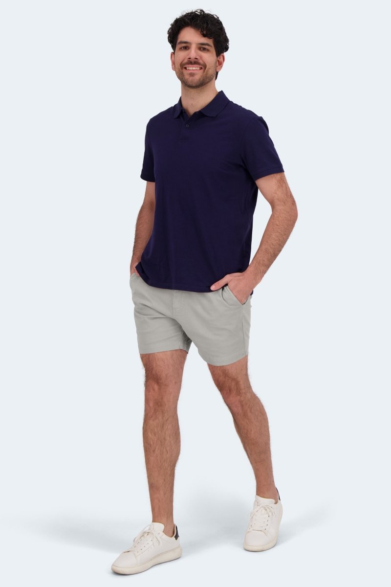 Man wearing Lunars * The Shorties light grey stretch cotton men's shorts paired with a navy polo and white sneakers