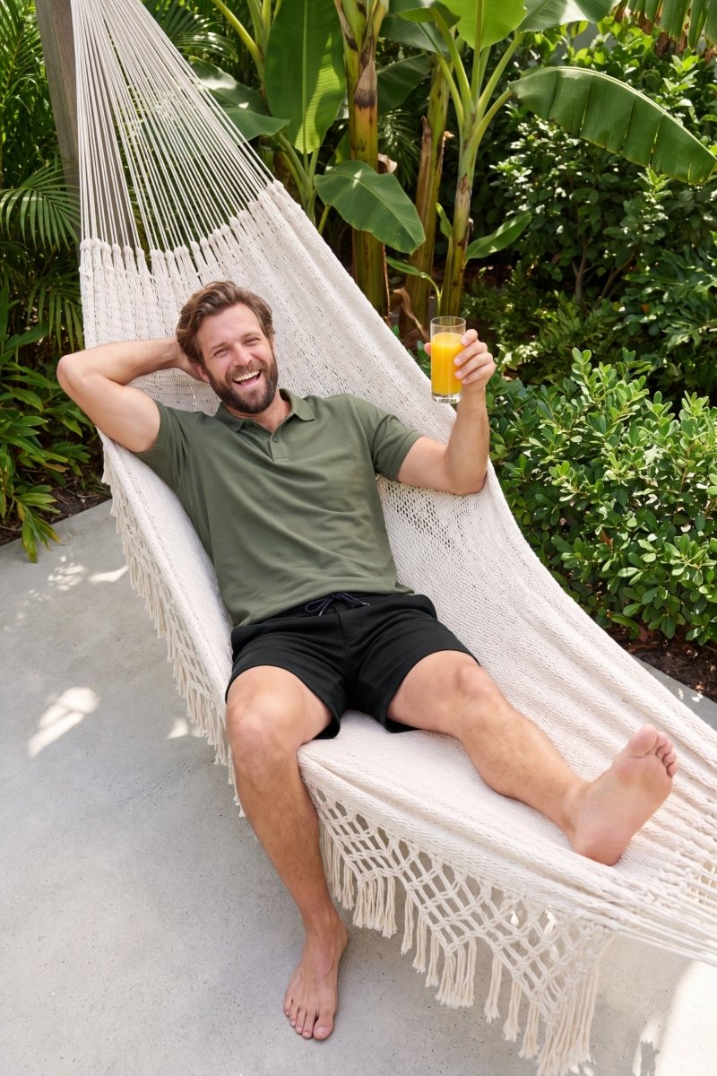 Frankster Midnights * The Comfies black Men's Shorts in fabric worn by a man relaxing in a hammock outdoors