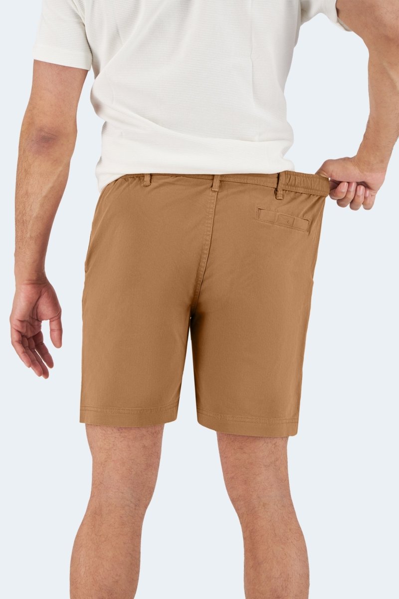 Man wearing Frankster brown stretch cotton men's shorts Mokas * The Everydays pulling waistband for fit demonstration