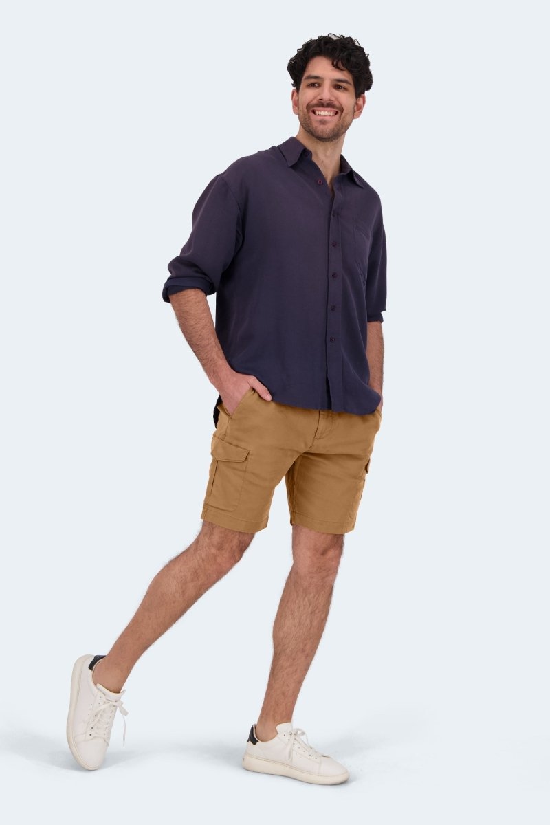 Man wearing Frankster brown Mokas * The Aussies cotton cargo men's shorts with navy shirt and white sneakers