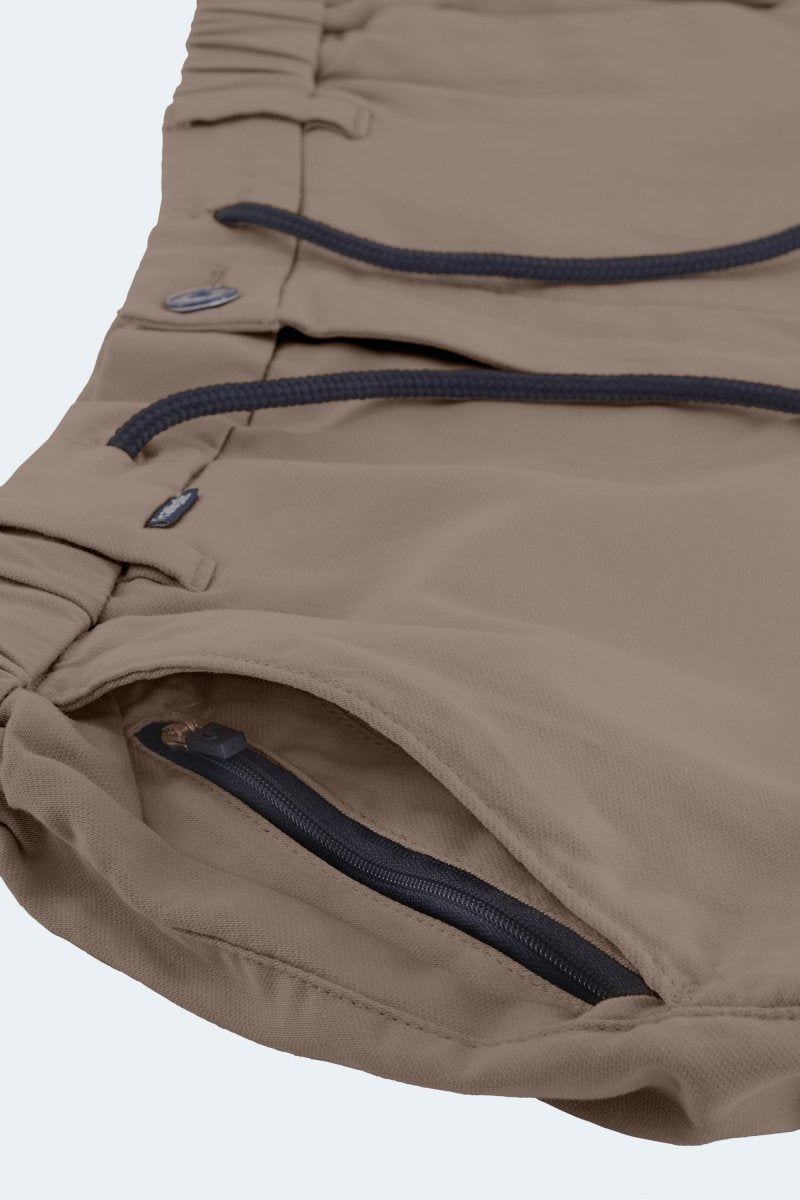 Close-up of Nomads * The Aussies men's shorts in dark khaki cotton with black drawstrings and zippered pocket by Frankster
