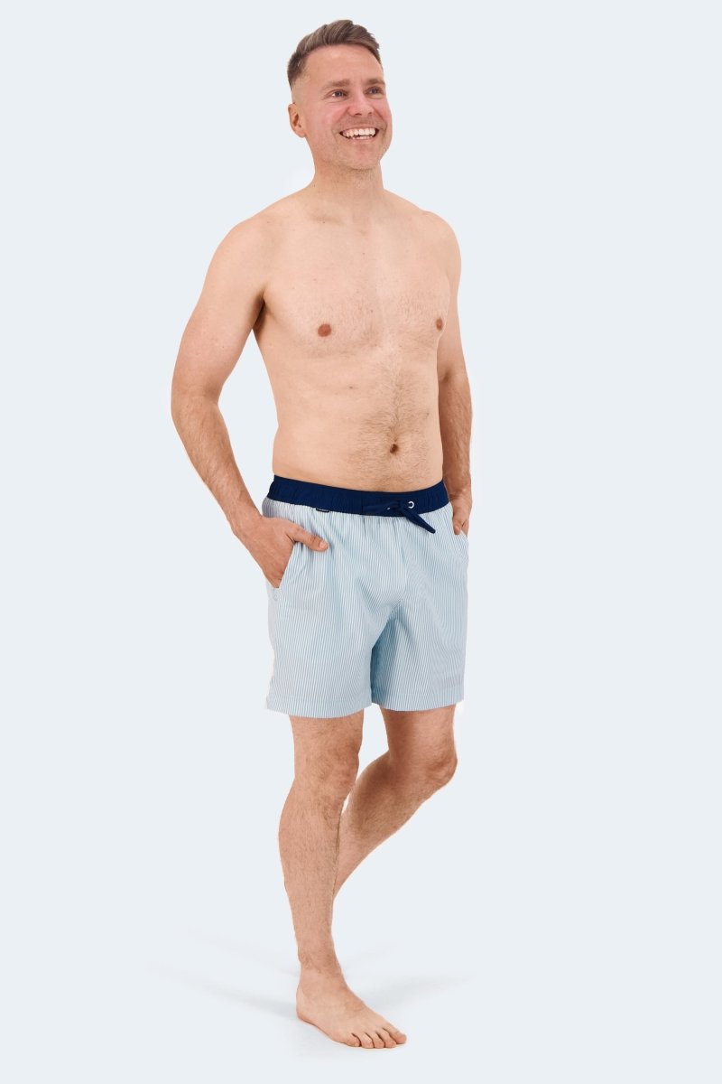 Palmers * The Swims by Frankster, light blue Men's Shorts in smooth swim fabric with a dark waistband, shown on a model