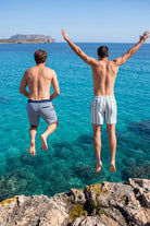 Poolsiders * The Swims by Frankster Men's Shorts in blue and white striped woven fabric shown on men jumping into the sea