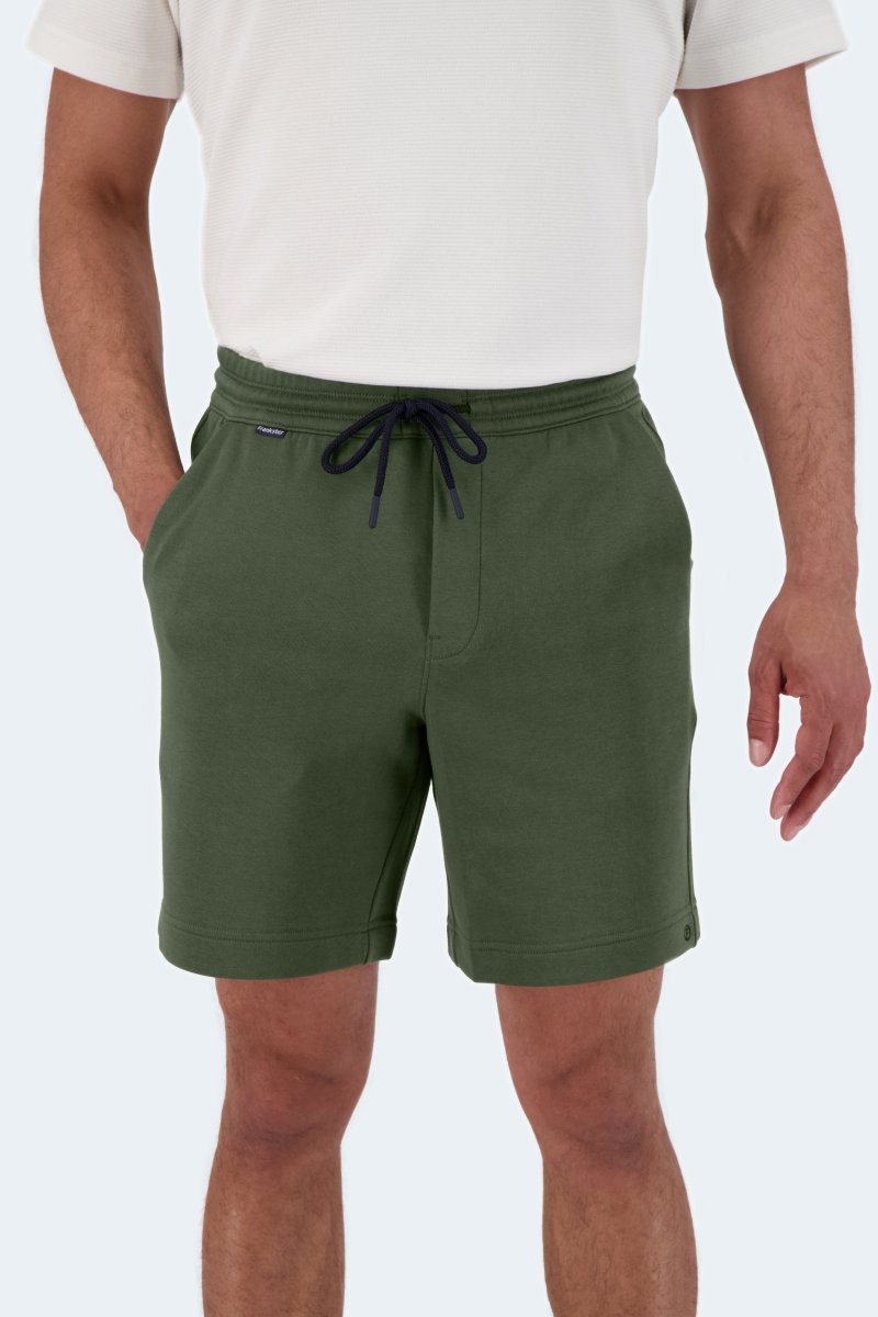 Front view of man wearing Rebels * The Comfies Frankster army green cotton men's shorts with drawstring waist