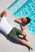 Rebels * The Comfies by Frankster green Men's Shorts in soft fabric worn beside a swimming pool