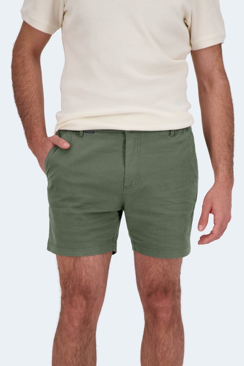Man wearing olive green Frankster Rebels * The Shorties stretch cotton men's shorts with white textured short sleeve top