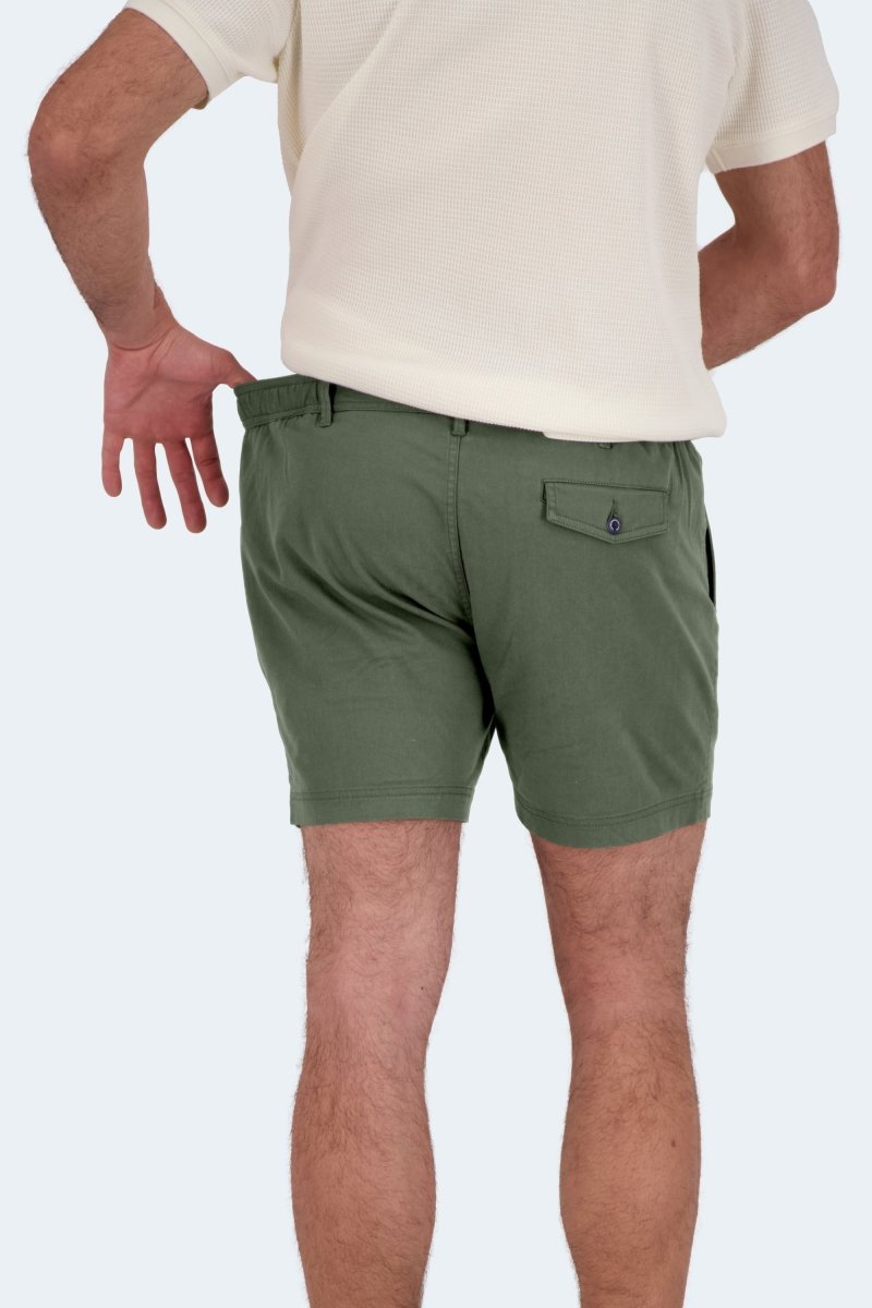 Rear view of a man wearing Frankster Rebels * The Shorties army green stretch cotton men's shorts with a white textured shirt