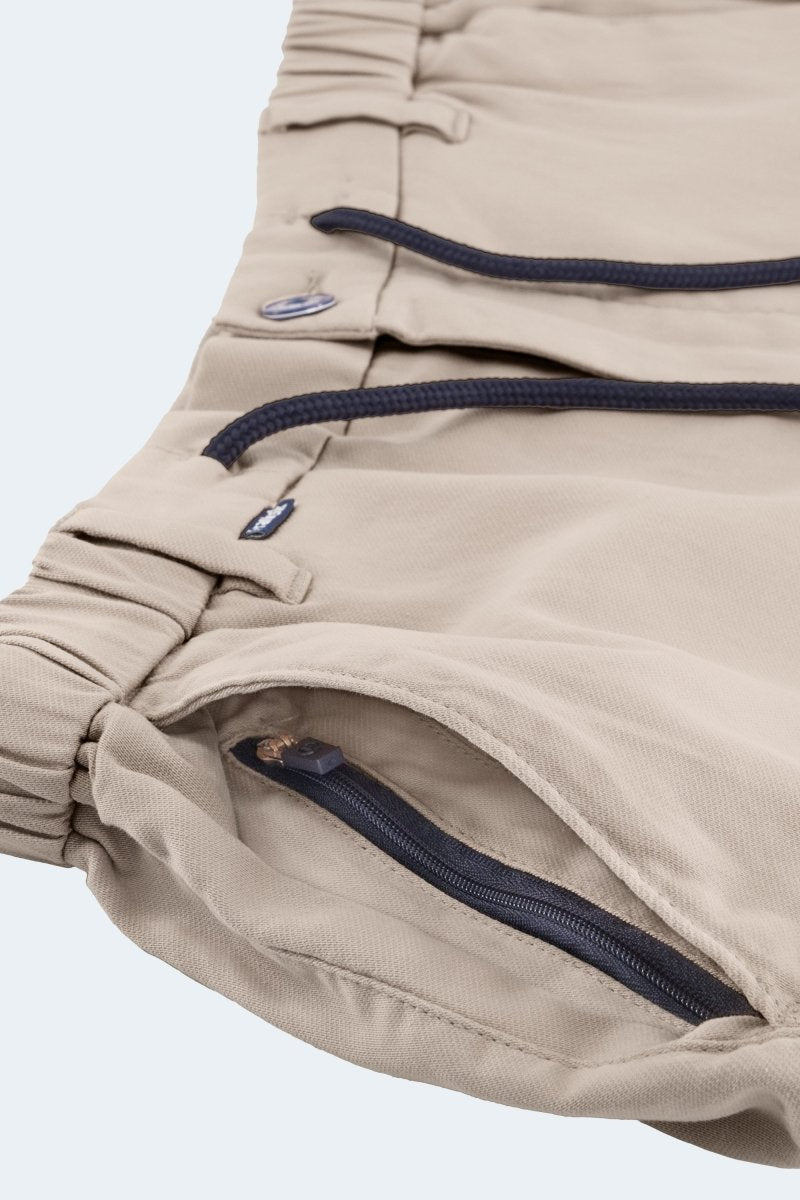Close-up of Shores * The Aussies light khaki premium cotton men's shorts by Frankster with elastic waistband and zippered pocket detail
