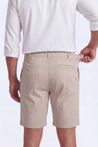 Back view of a man wearing beige Shores * The Everydays men's shorts by Frankster, made from soft, comfortable material with a partly elasticated waistband.
