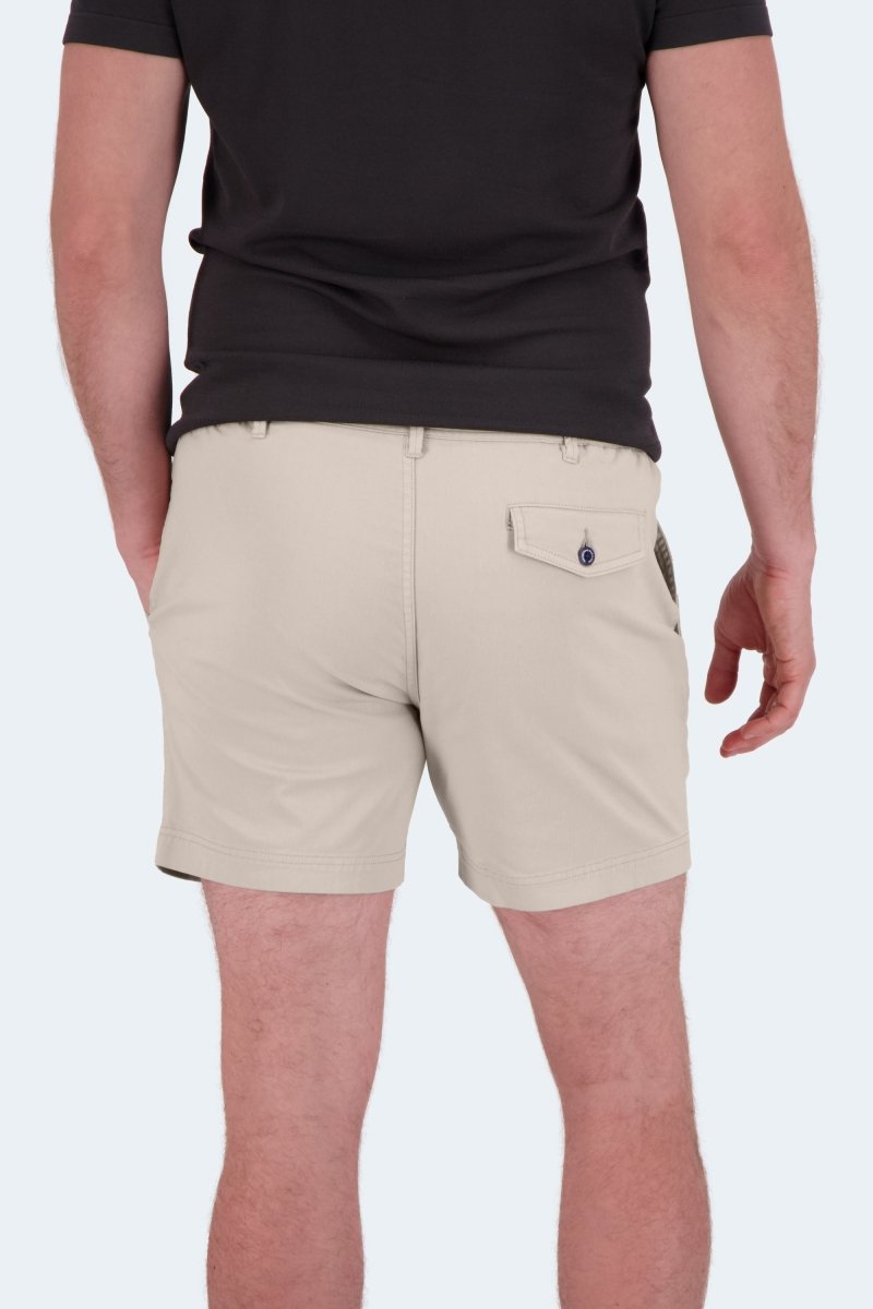 Back view of Shores * The Shorties light khaki stretch cotton men's shorts by Frankster worn with a black t-shirt