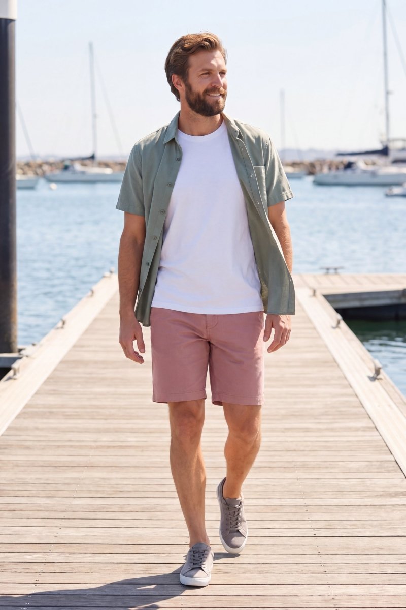 Man walking on a dock wearing dusty pink Sundowners * The Everydays men's shorts by Frankster, featuring lightweight, comfortable fabric perfect for casual wear.