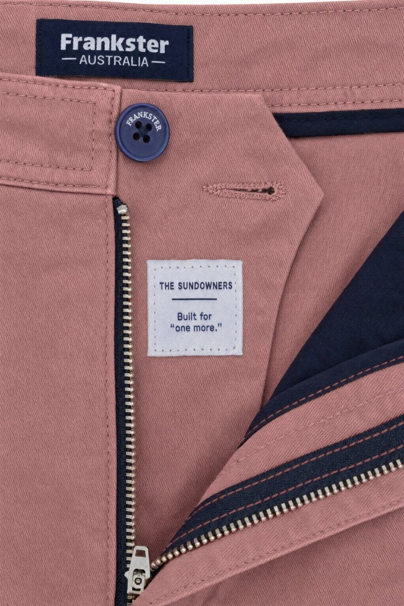 Close-up of Frankster Sundowners * The Everydays men's shorts in dusty rose colour, featuring cotton fabric, navy button and zipper detail, and inner navy lining.