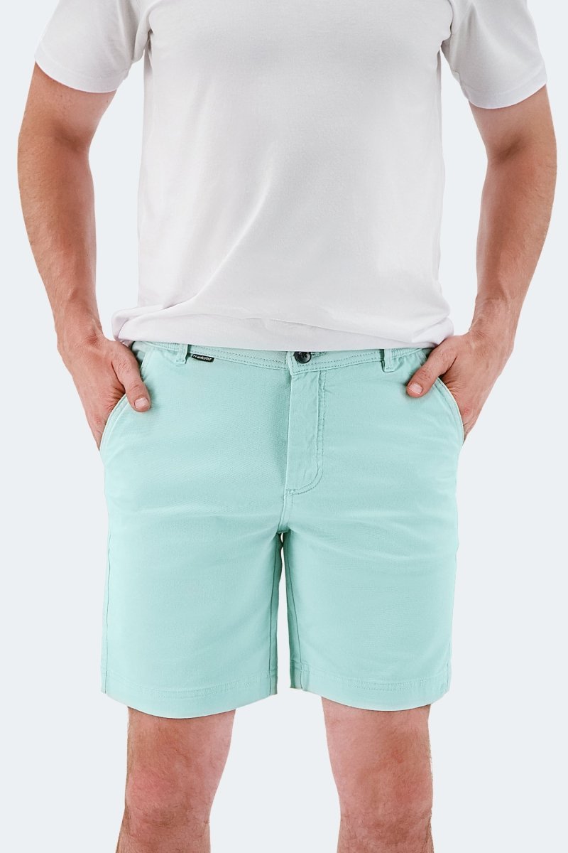 Man wearing light green stretch cotton men's shorts from Frankster Rays * The Everydays collection with white t-shirt