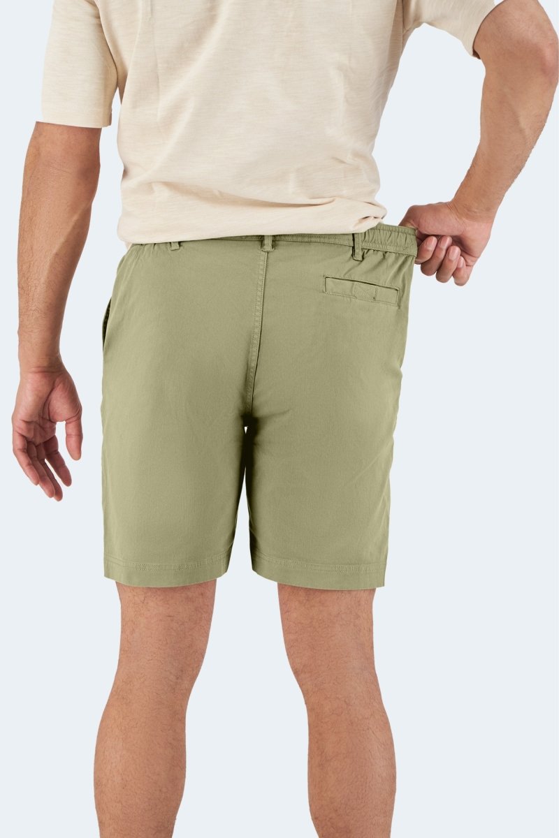 Man wearing olive green stretch cotton men's shorts from Virgins * The Everydays by Frankster, showing back with hand pulling waistband