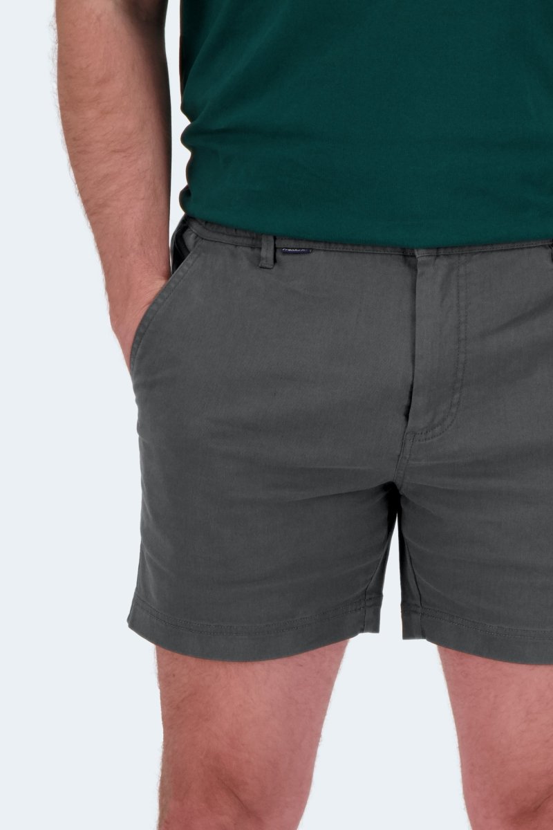 Man wearing dark grey Volcans * The Shorties stretch cotton men's shorts by Frankster with hands in pockets