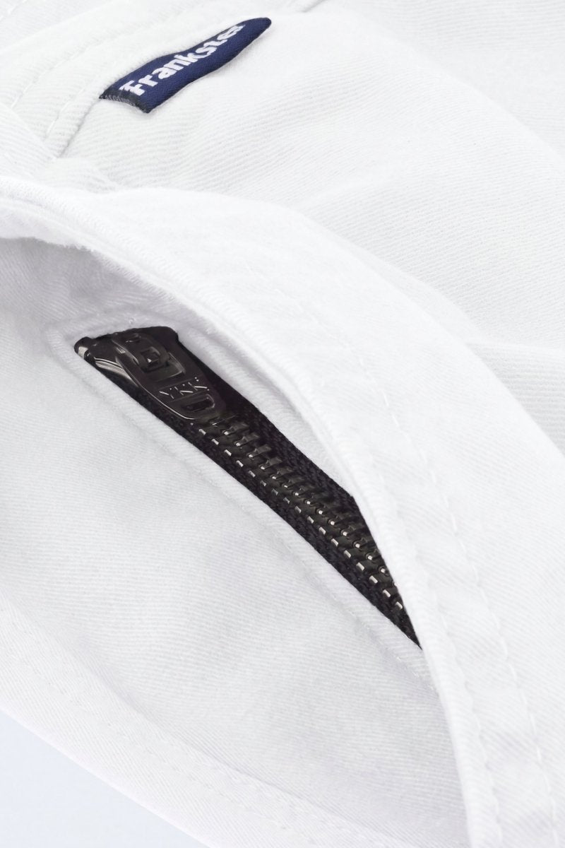 Close-up of white fabric men's shorts from Frankster featuring a black zipper pocket detail, highlighting comfort and premium material from Whitecaps * The Everydays.